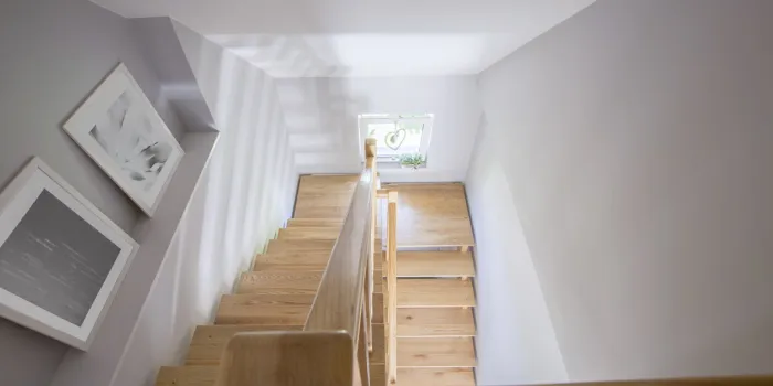 high angle on posters and wooden stairs in the hall of house interior real photo high angle on posters and wooden stairs in the hall of house interior real photo