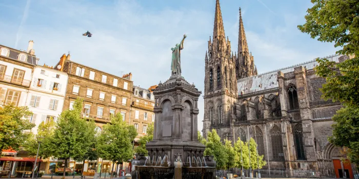 morning view on the victory square with monument and cathedral in clermont-ferrand city in france