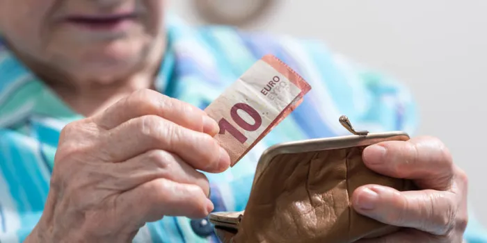 senior woman taking out a banknote from her wallet