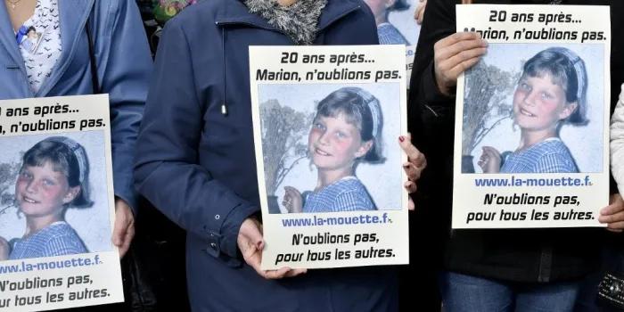 people take part in a silent march in tribute to marion wagon (placards), on november 14, 2016 in agen, on the 20th anniversary of her disappearance (photo by georges gobet   afp)